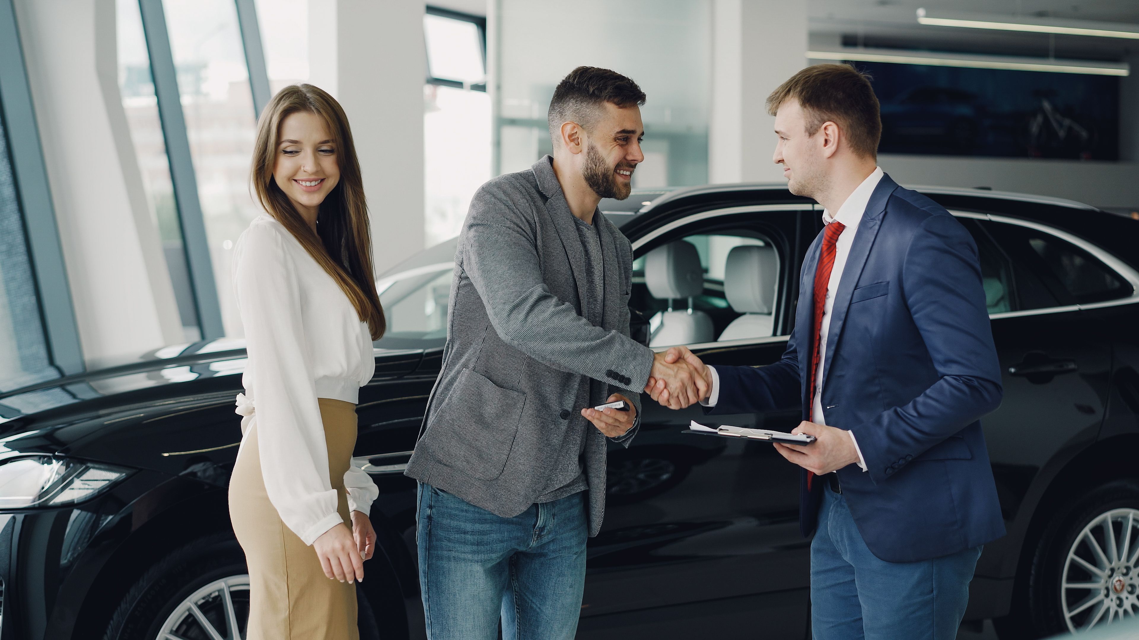 G-Inspired Automall Washington Illinois team member reviewing trade-in appraisal paperwork openly with a customer