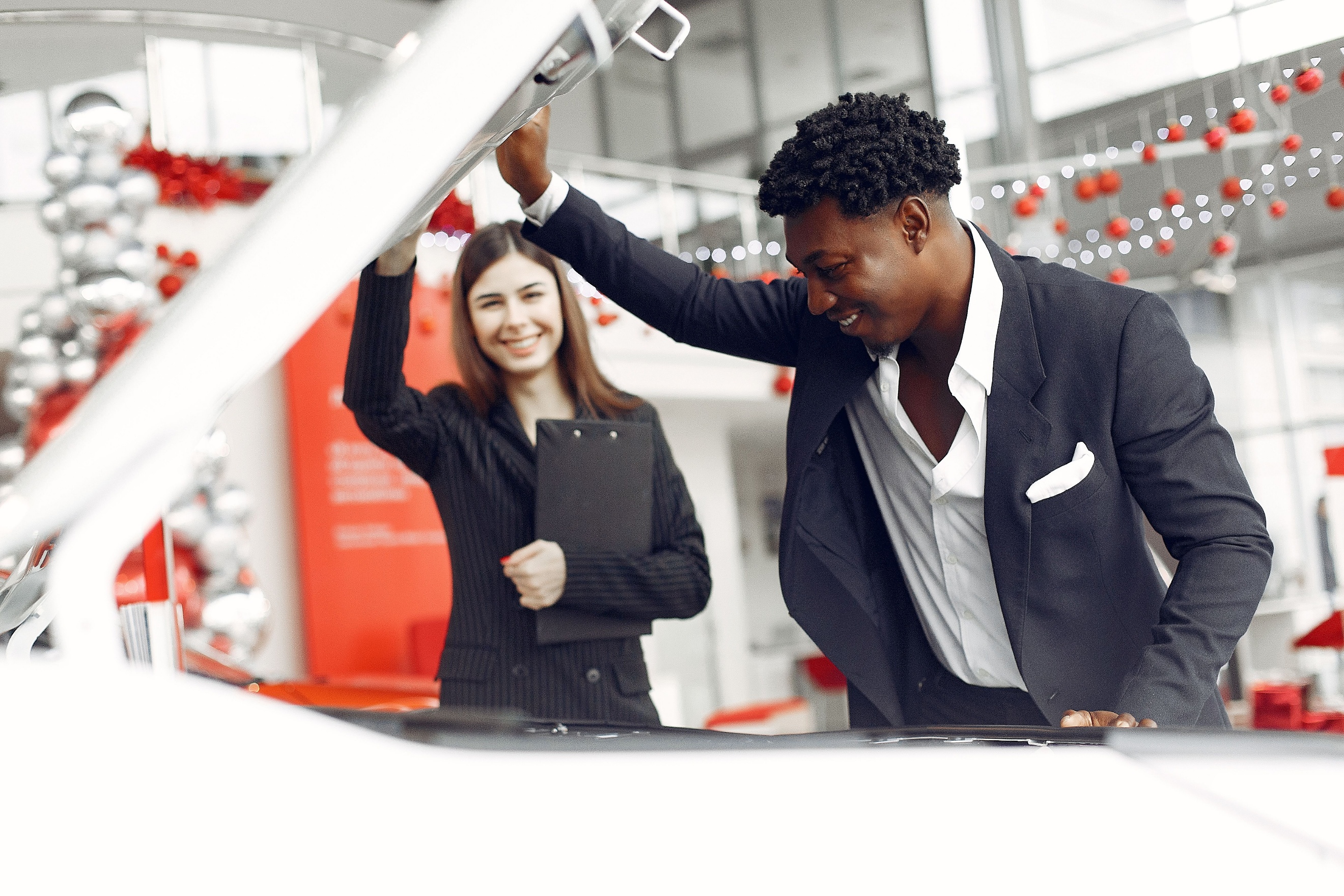 G-Inspired Automall team member walking a customer through a transparent vehicle inspection and purchase process at the Illinois or Wisconsin location