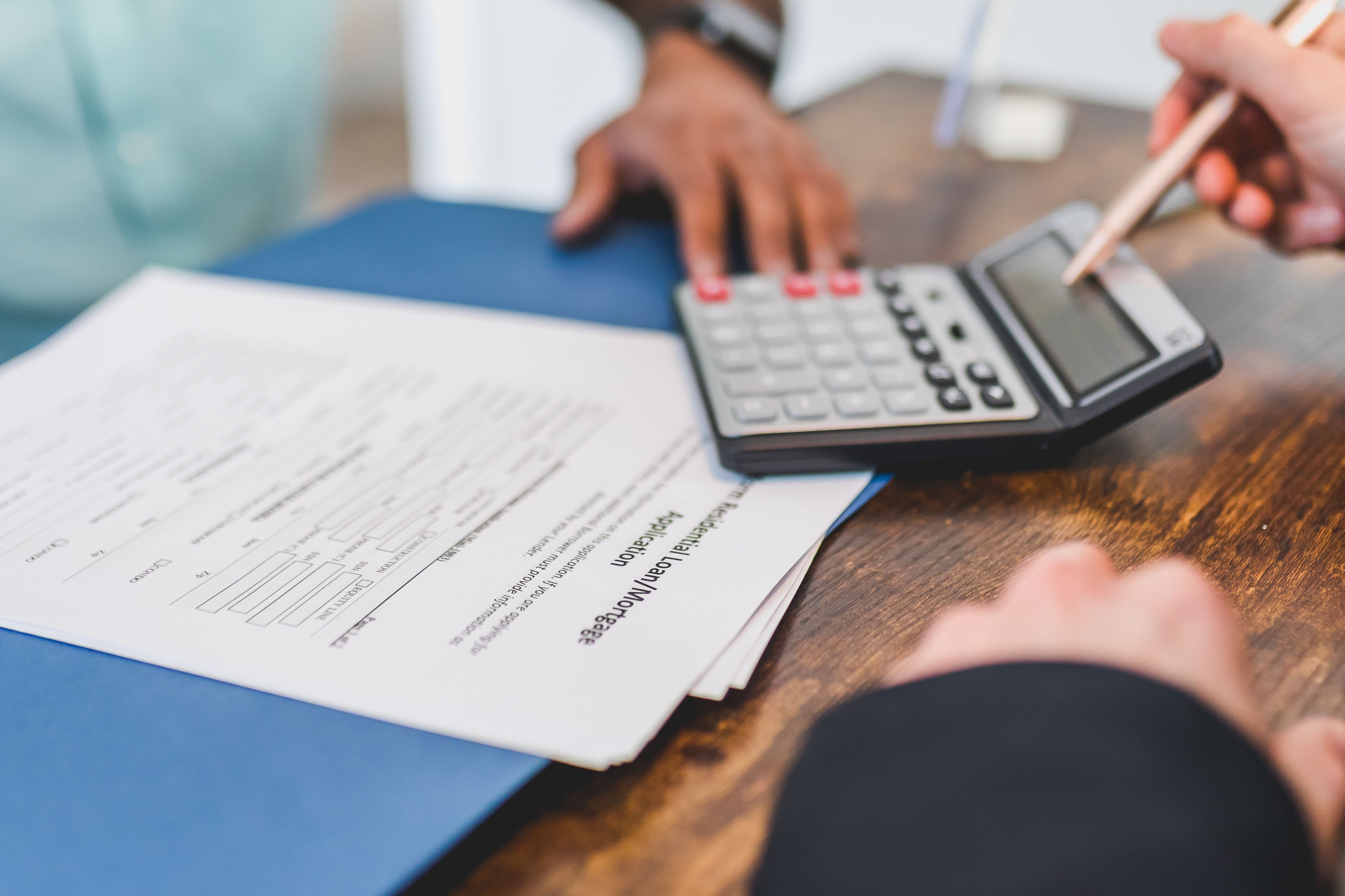 Calculator and vehicle contract representing the true total cost of buying a cheap used car in Illinois and Wisconsin